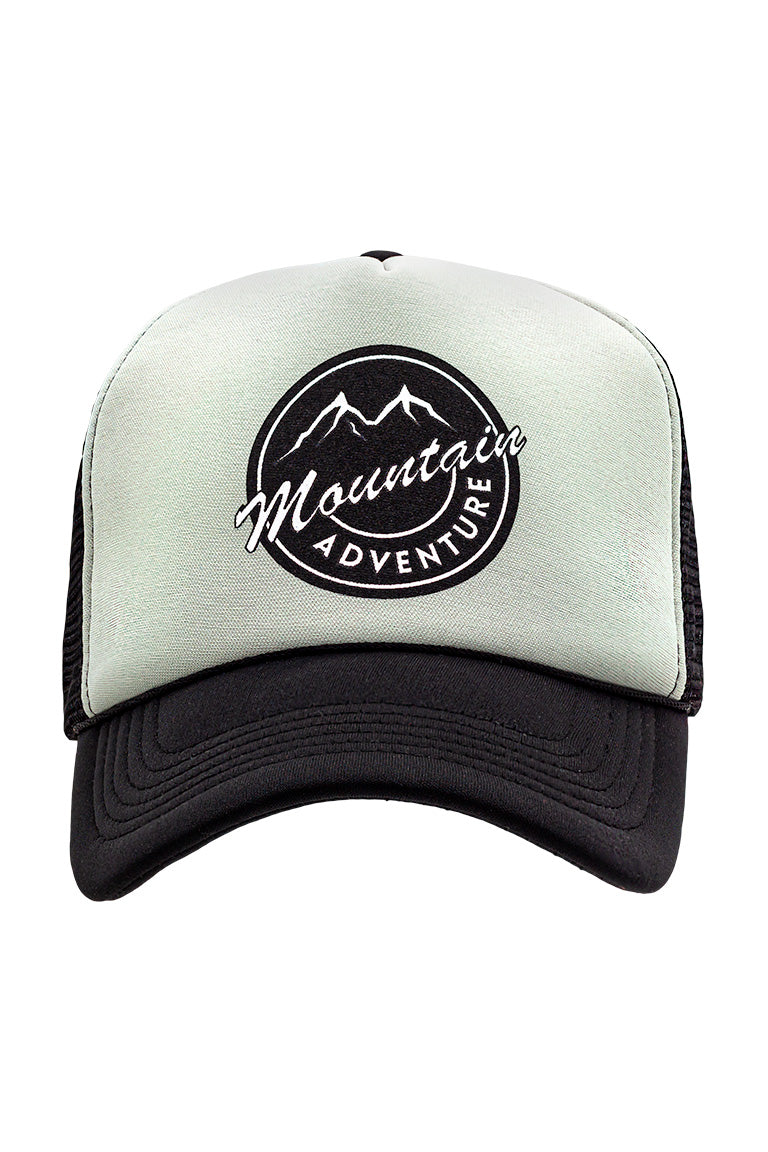 Side view of foam trucker hat with black visor and gray foam top. Breathable mesh in back of hat. Design on cap of a mountain inside a circle with the words mountain and adventure underneath.
