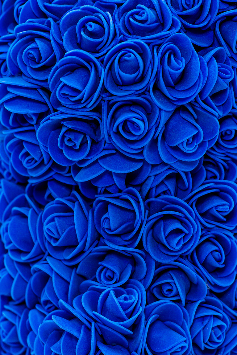 A close up shot of navy blue foam shaped roses
