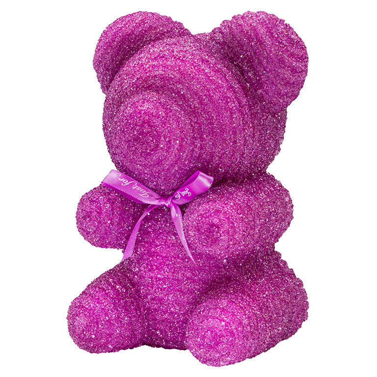 A decorative bear with purple plastic glitter covered around the styrofoam bear.