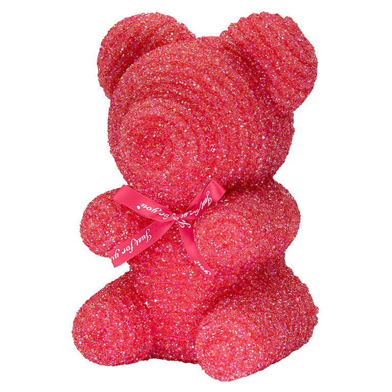A decorative bear with darker red plastic glitter covered around the styrofoam bear.