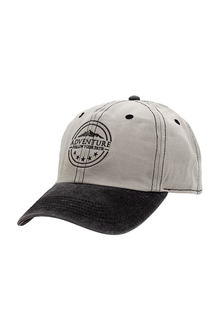Side view of base baseball cap. Black color visor with grayish cap. With an embroidered design of a mountain with the phrase underneath"Adventure follow your own path"