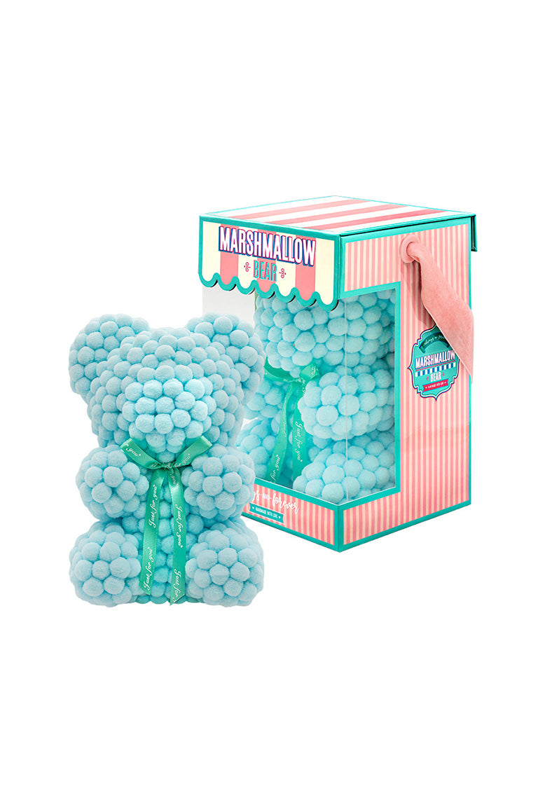 Light blue bear shape ornament covered in tiny foam balls with product packaging in the back