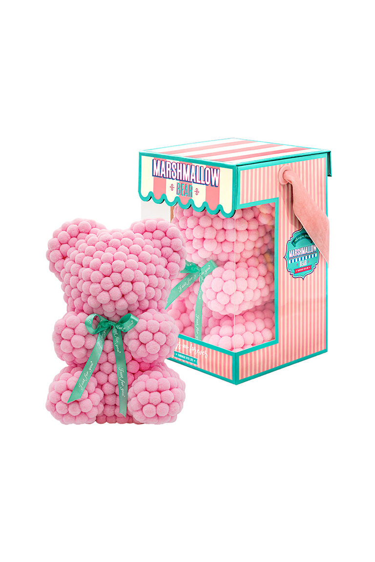 Light pink bear shape ornament covered in tiny foam balls with product packaging in the back