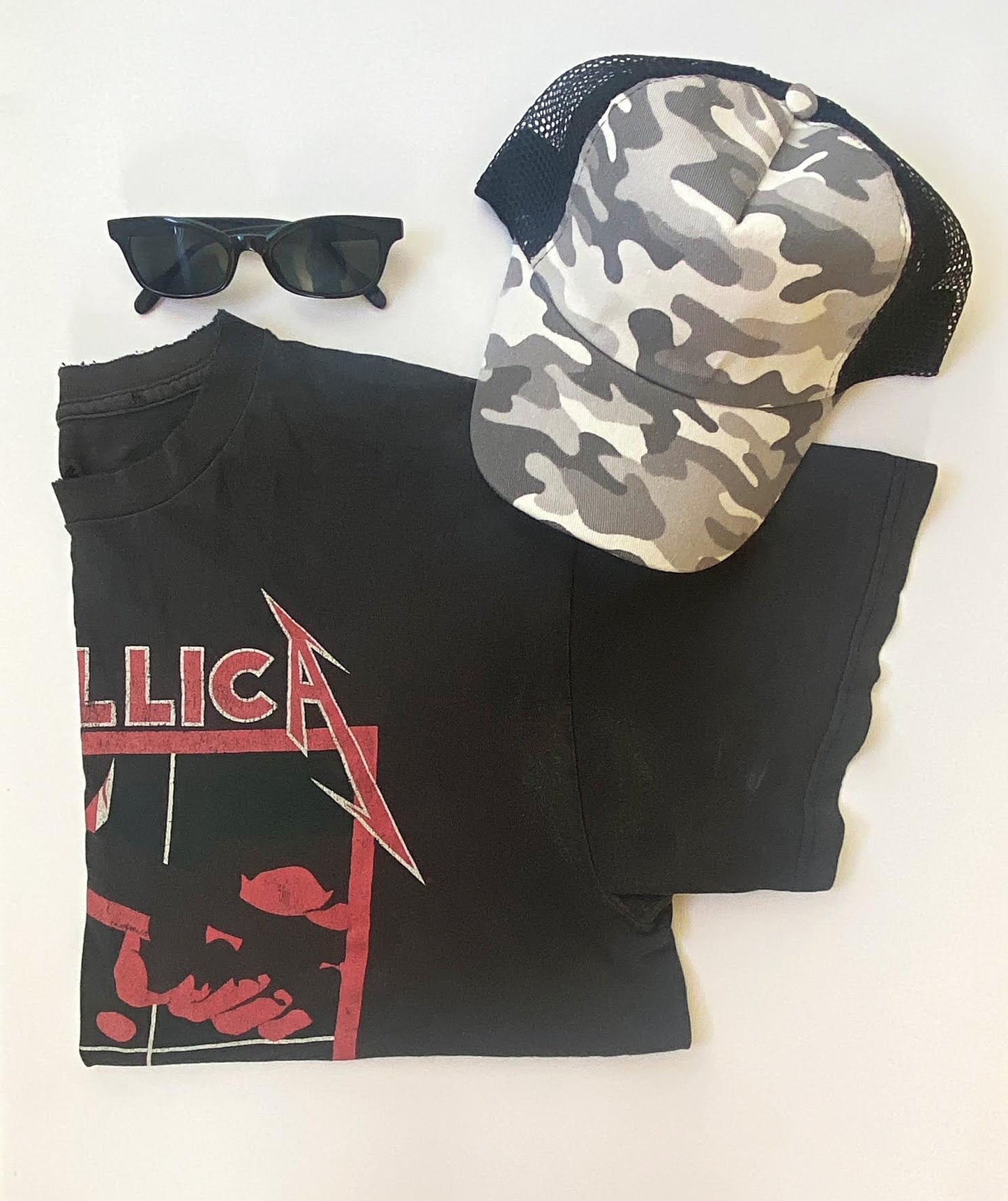 A display of items of clothing next to the gray camo design snapback hat