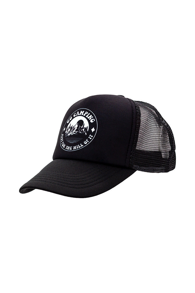 Side view of a foam trucker hat all black. With a white circle design of a mountain scene and words around saying "Go camping. Just for the hill of it"