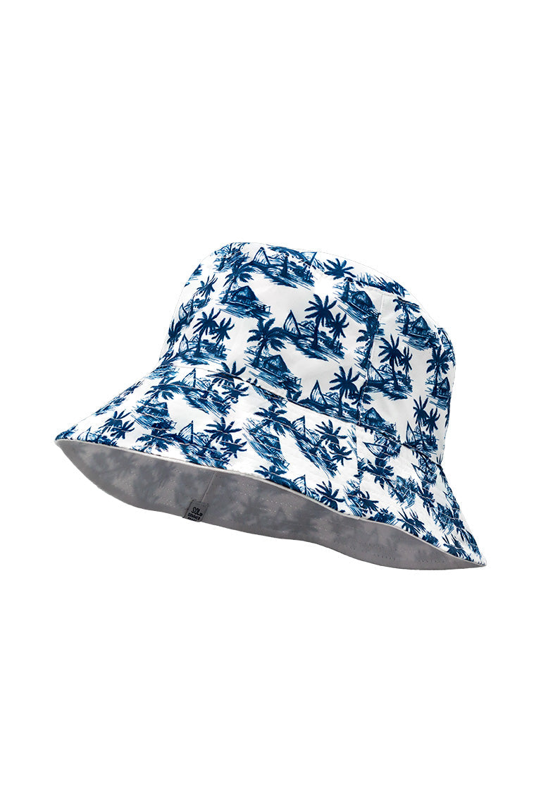 Side view of a reversible floppy bucket hat. With a tropical pal tree design and an all white color inside.