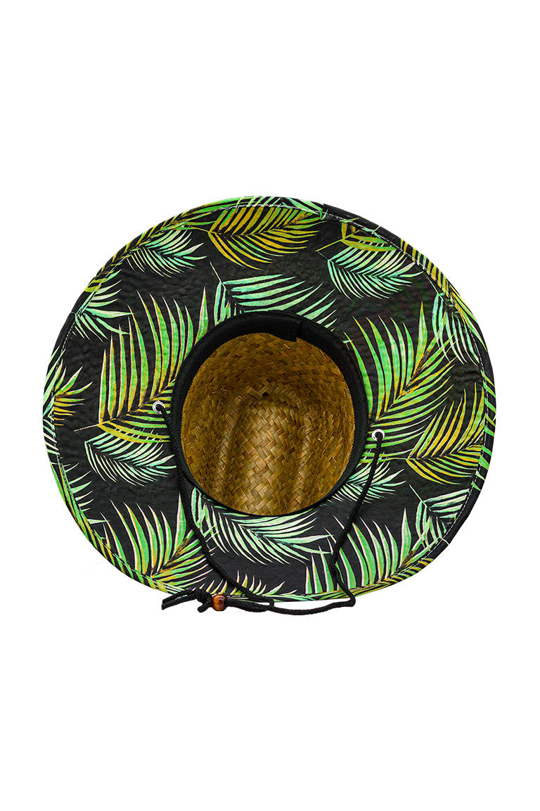 Bottom view of a straw hat with a green palm leaf design pattern underneath the shaded visor with ablack chin strap