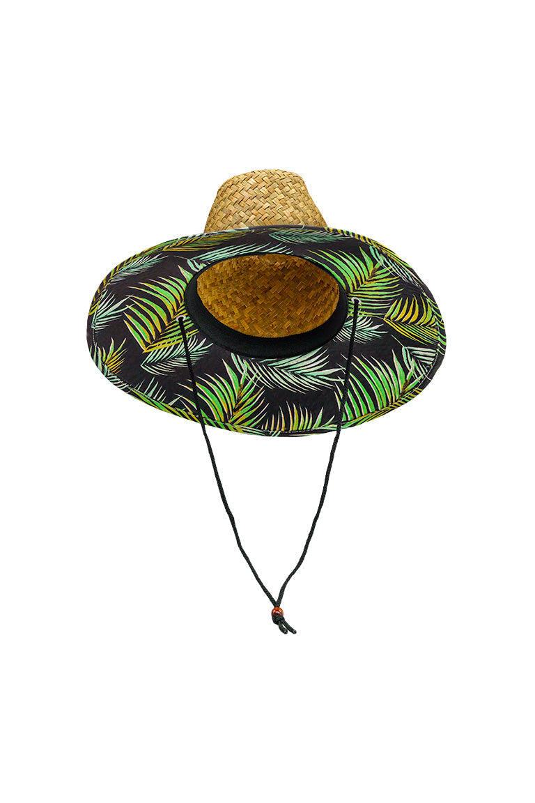 Side view of a straw hat with a green palm leaf design pattern underneath the shaded visor with ablack chin strap