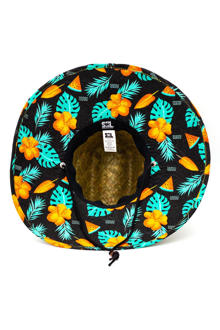 Bottom view of a straw hat with a tropical watermelon design pattern underneath the shaded visor with ablack chin strap