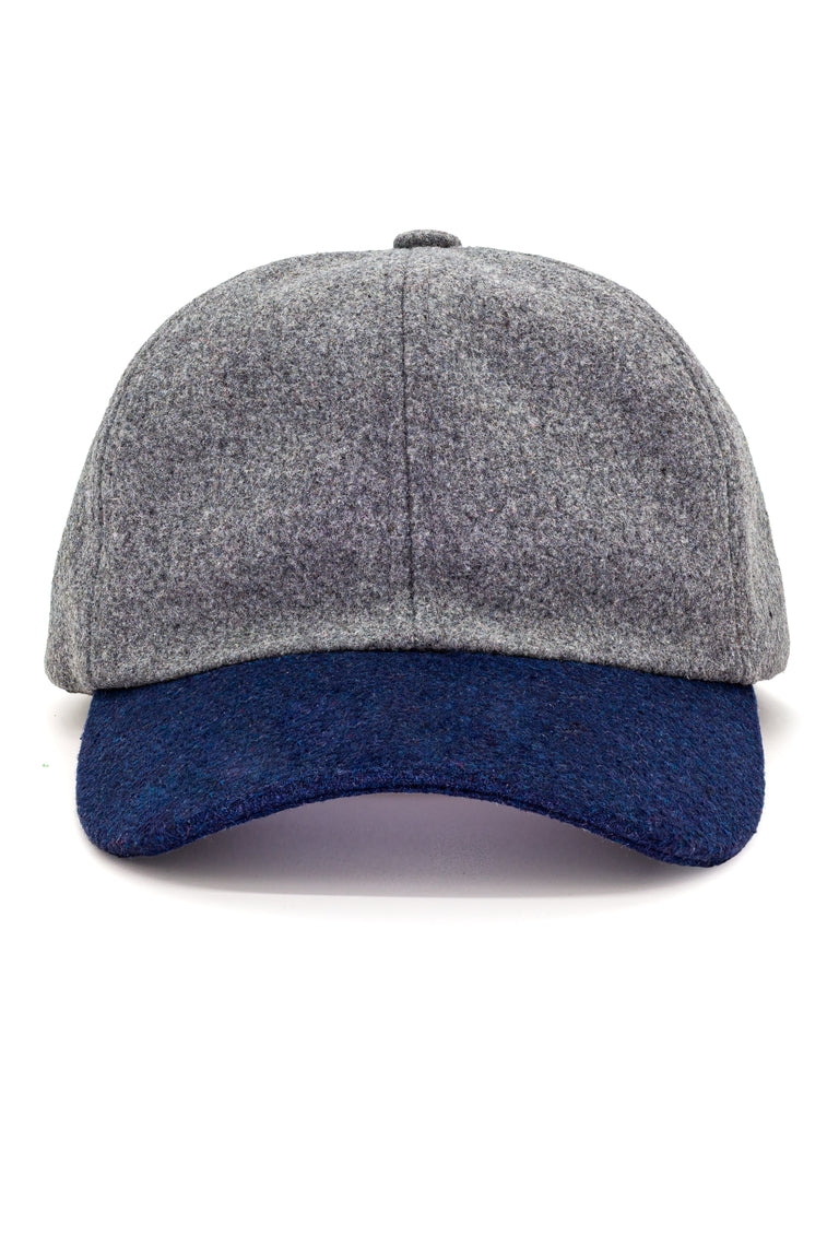 A baseball call with a navy visor and a gray cap made for winter