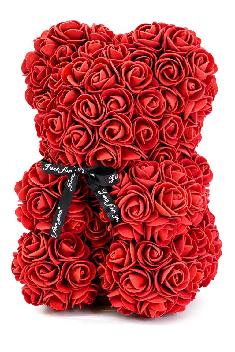 A bear shape decorative piece covered in red color foam flowers. With a black bow ribbon around underneath the head.