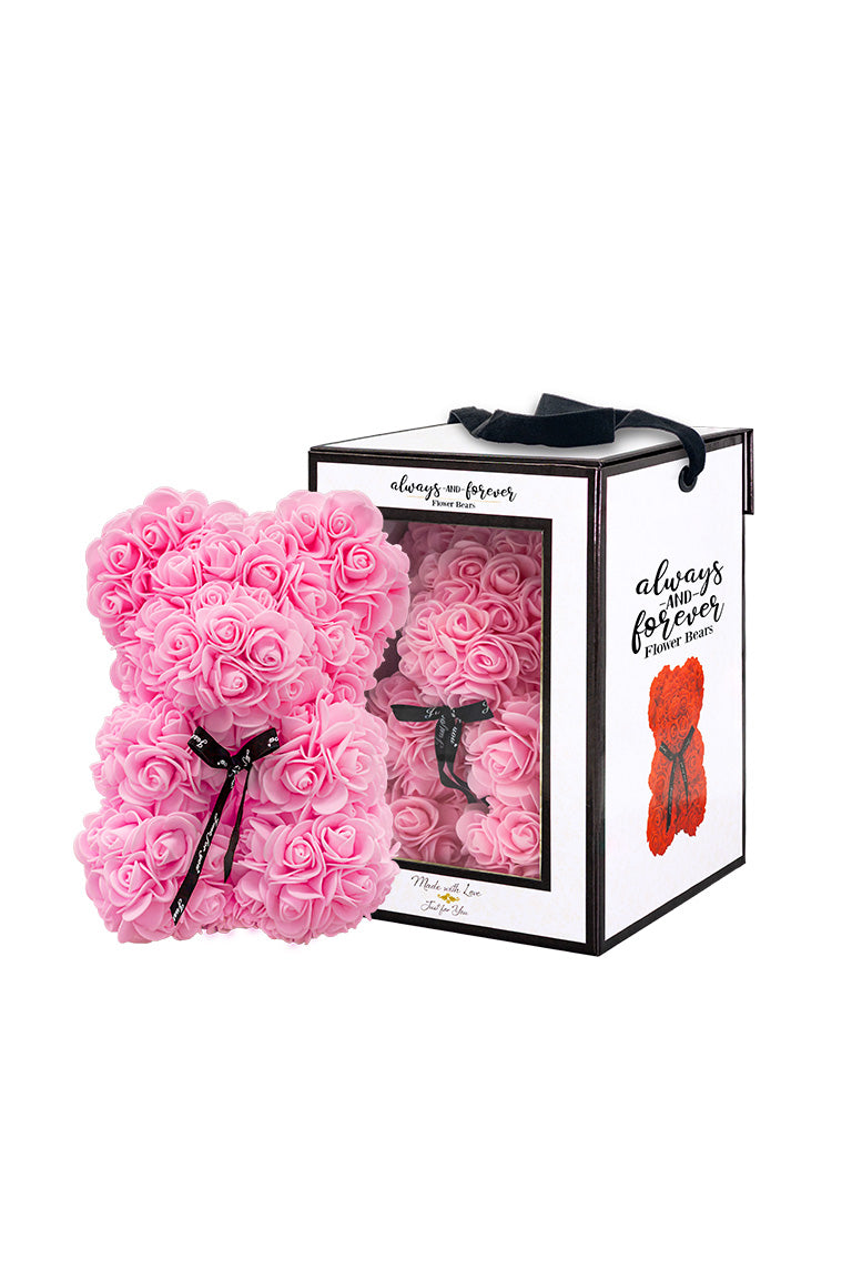 A bear shape decorative piece covered in pink color foam flowers. With a black bow ribbon around underneath the head. Next to a white packaging box