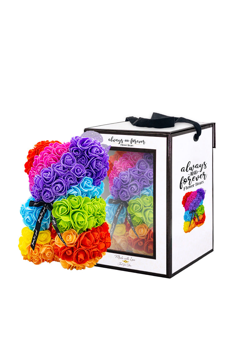 A flower bear decoration cover in foam roses making a rianbow color pattern. With white box packaging next to it