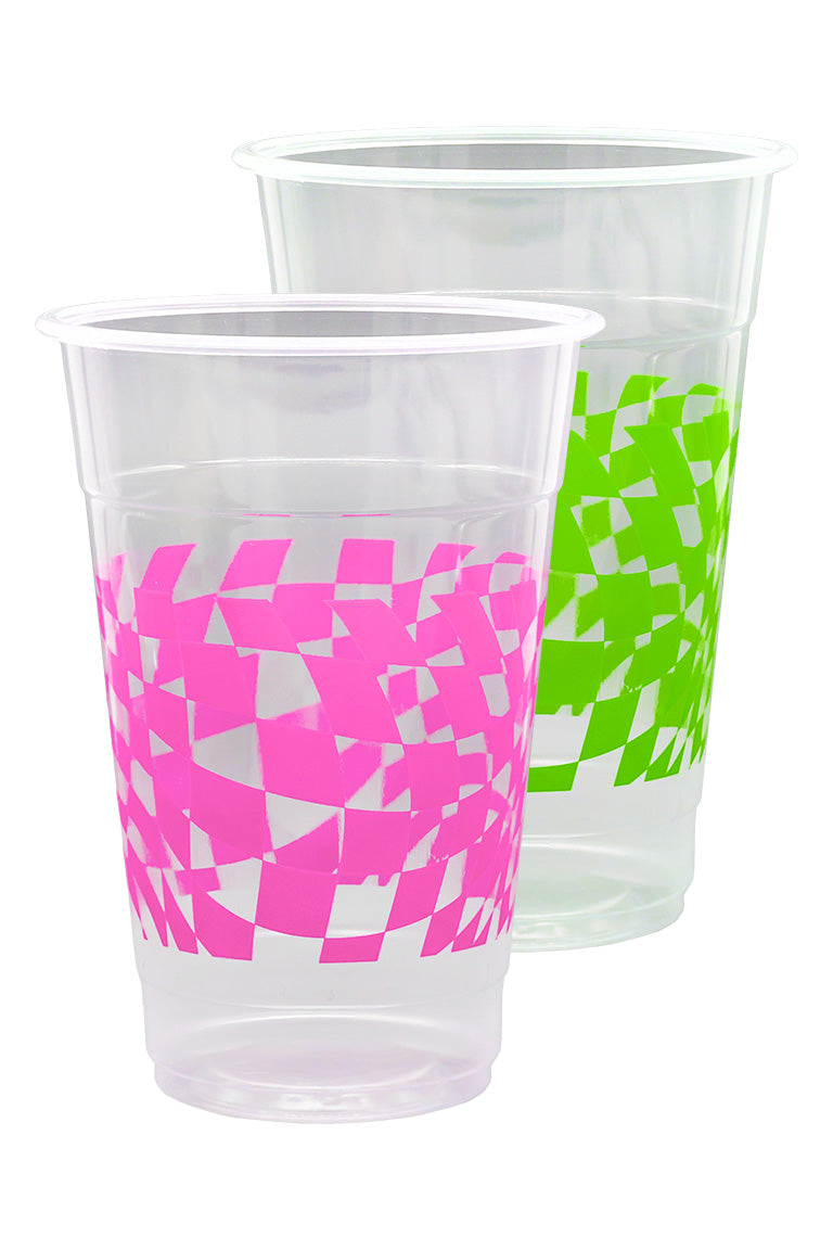 Close up of beer pong cups. 1 clear plastic cup with a pink checkered design and the other cup with a green checkered design.
