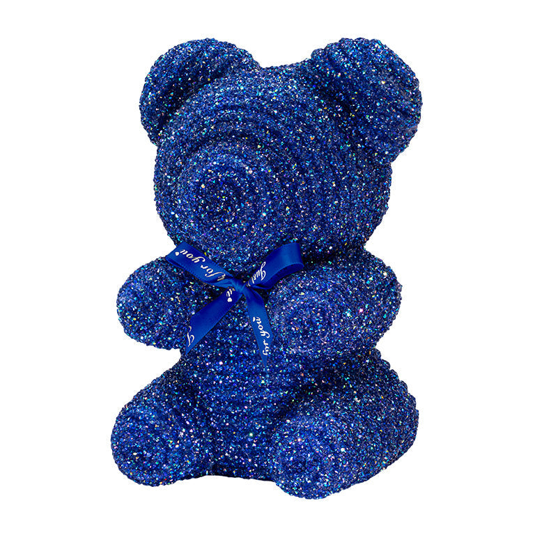 A decorative bear with dark blue plastic glitter covered around the styrofoam bear. 