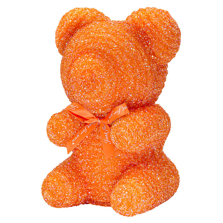 A decorative bear with orange plastic glitter covered around the styrofoam bear. 