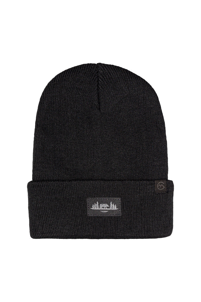 A black beanie with a small square patch of a bear surrounded by trees