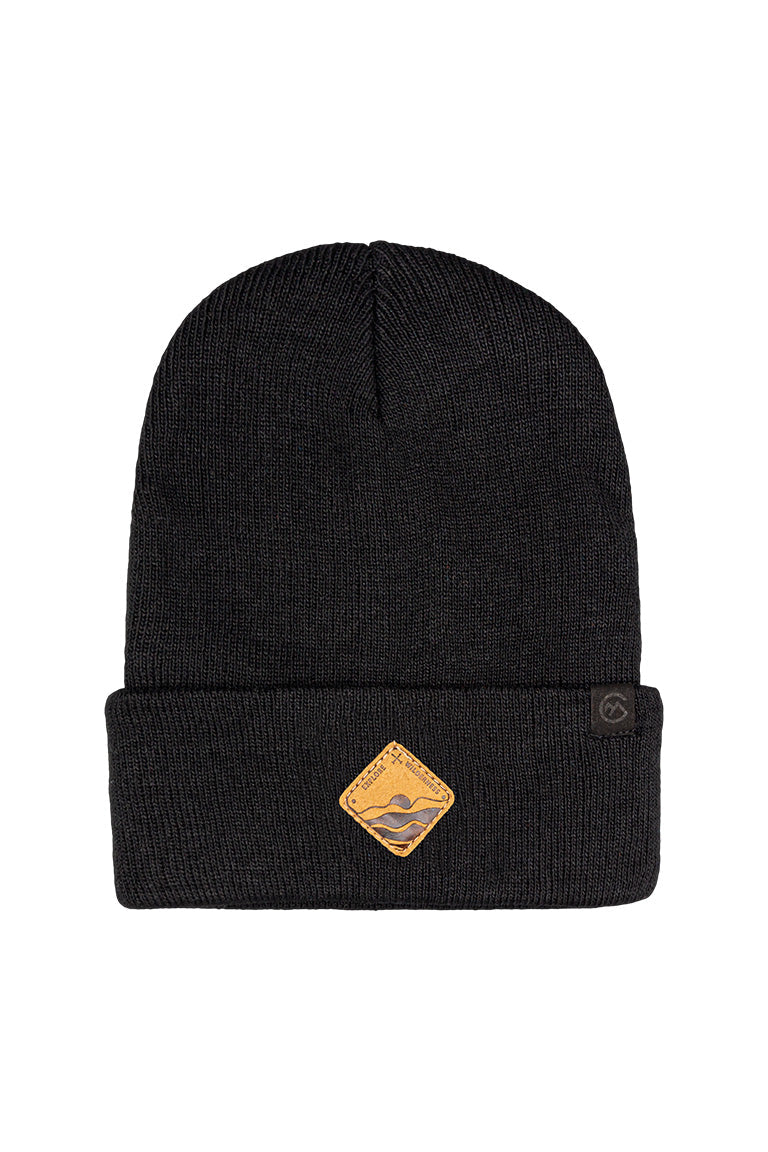 A black beanie with a small diamond shape patch of sun rising behind an ocean wave