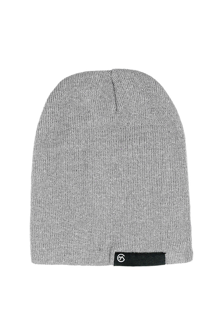 A gray beanie with a black small rectangle tag at the base of the cap